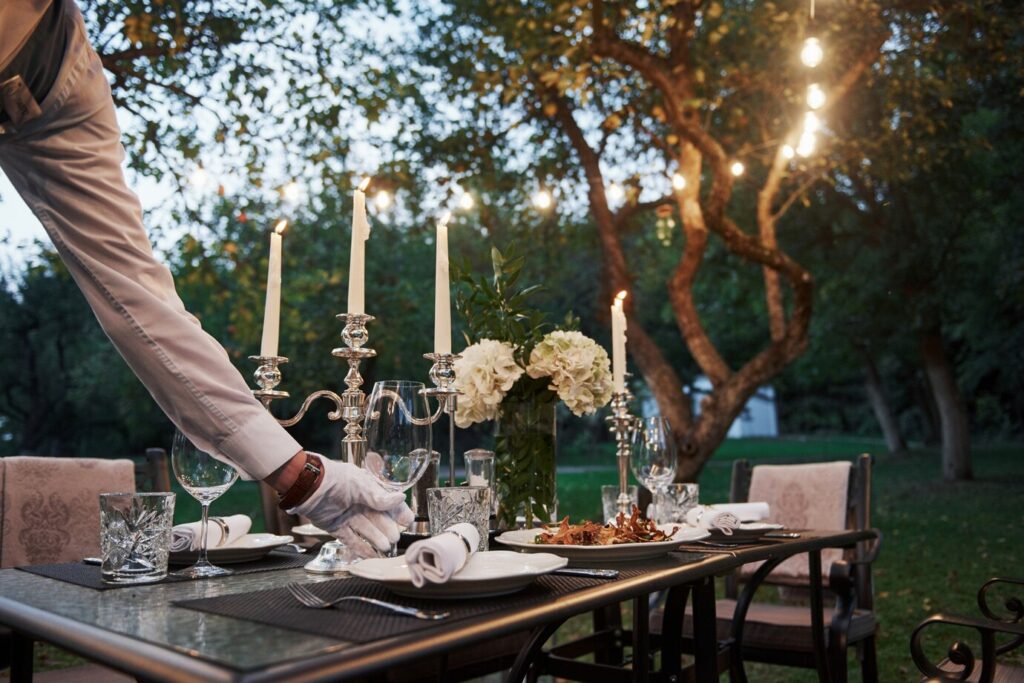 waiter-hand-gloves-worker-is-engaged-serving-table_146671-14407